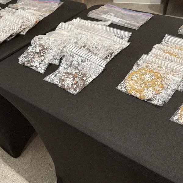 Bags of homemade holiday cookies laid out on a table